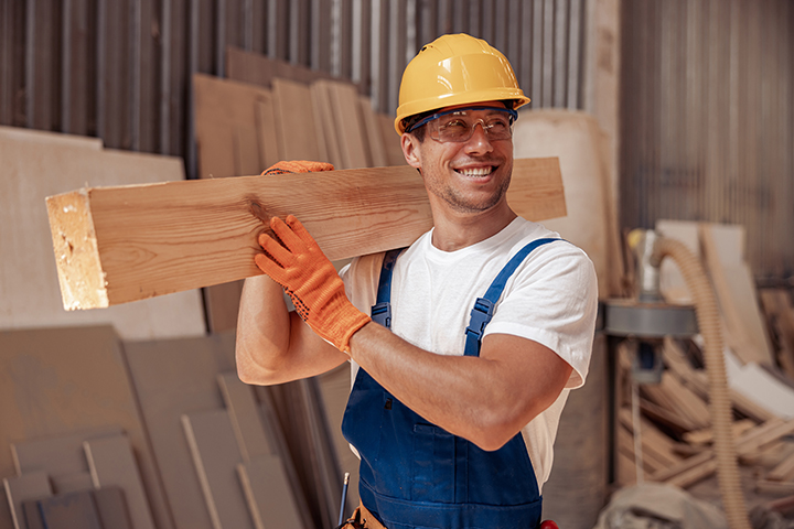 repairman holding a beam